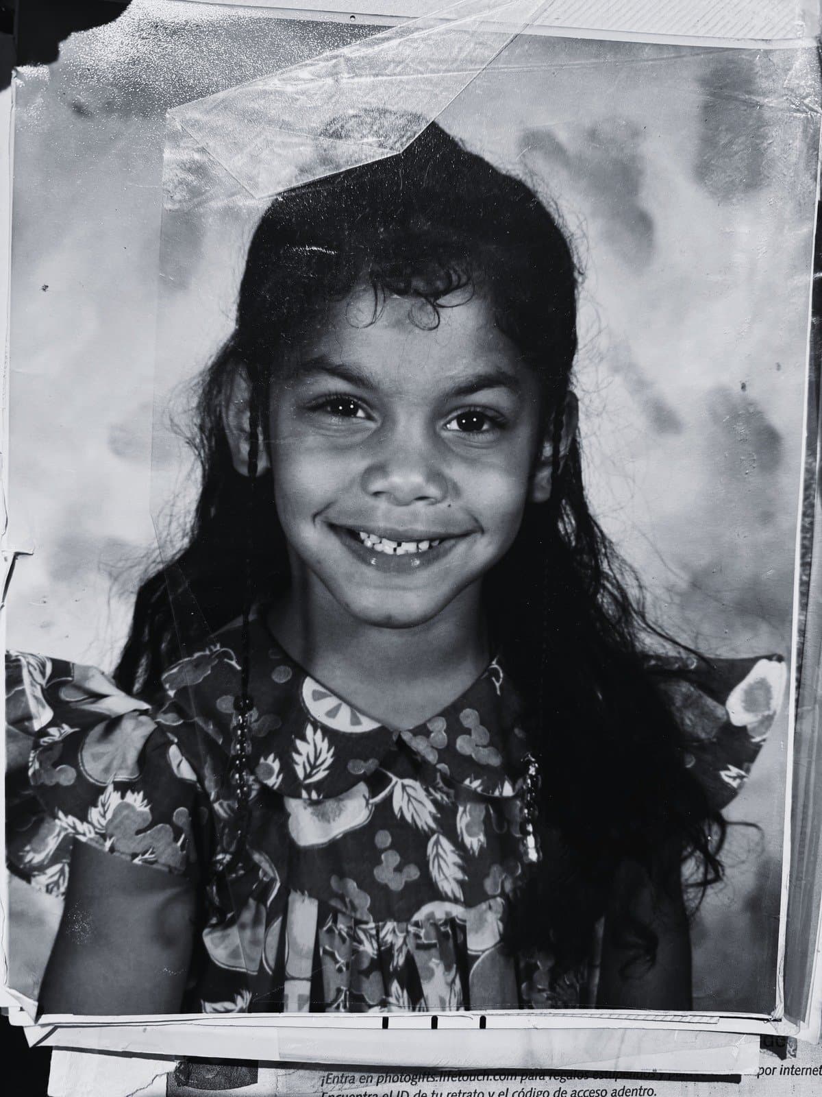 A childhood photograph of Mary, smiling